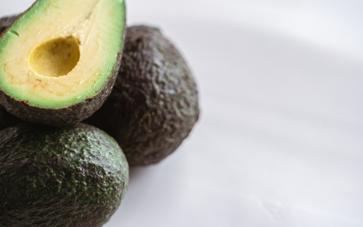 Fresh avocado halves showing bright green flesh after cutting