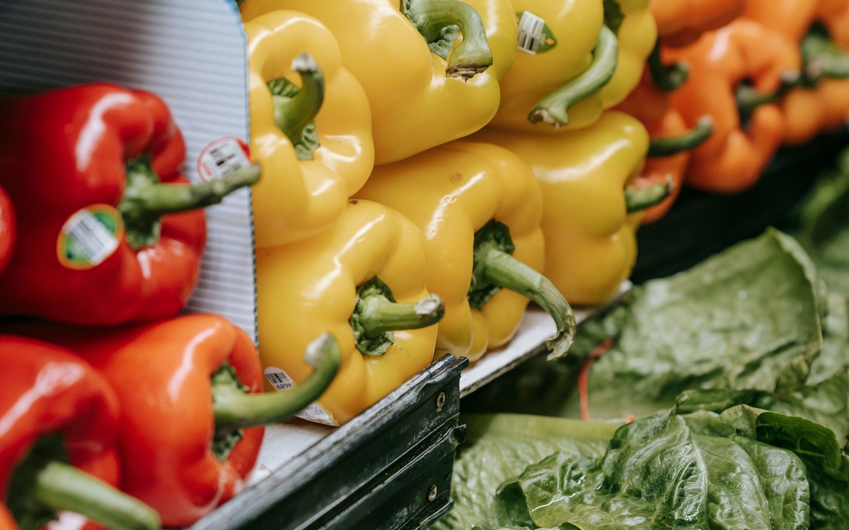 Fresh colorful bell peppers displayed in a grocery produce section