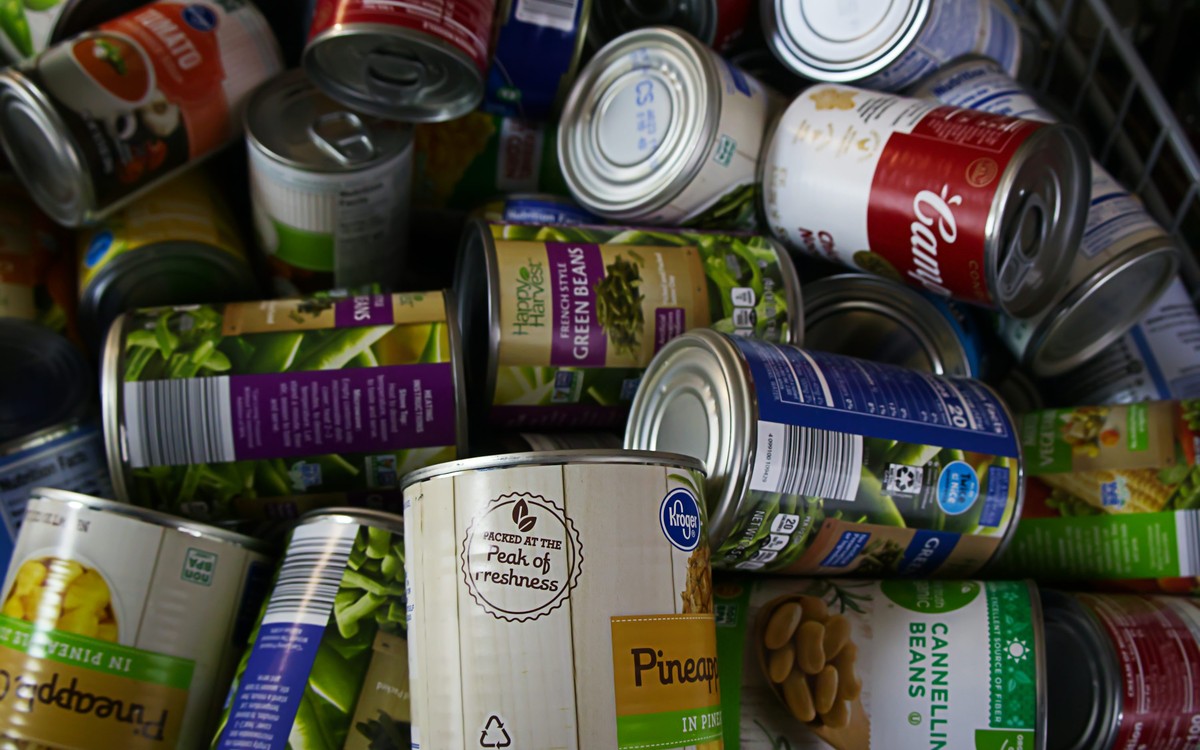 A group of canned foods arranged together as pantry staples