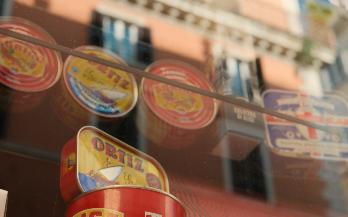 Cans of tuna and other canned fish displayed in a shop