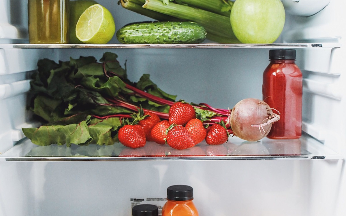 Fresh produce arranged on refrigerator shelves