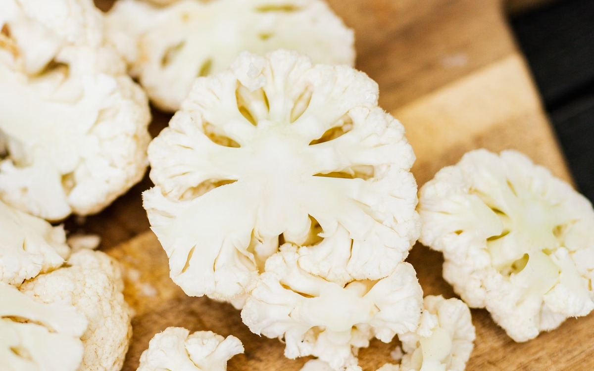 Fresh cauliflower on a cutting board ready to be washed and prepared