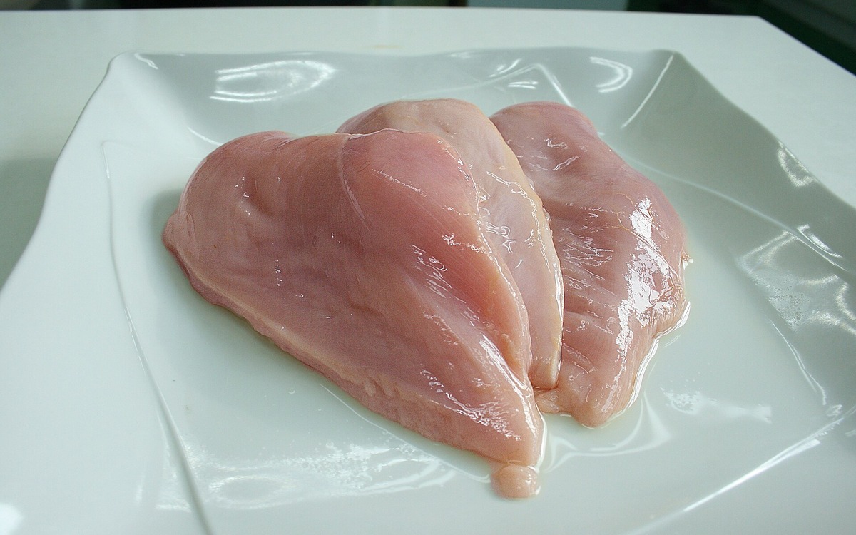Raw chicken breast representing safe preparation and thawing before cooking