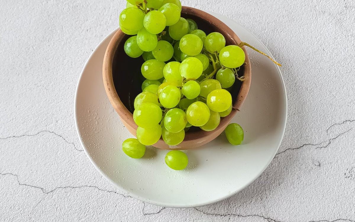 Fresh green grapes in a bowl ready to rinse and serve