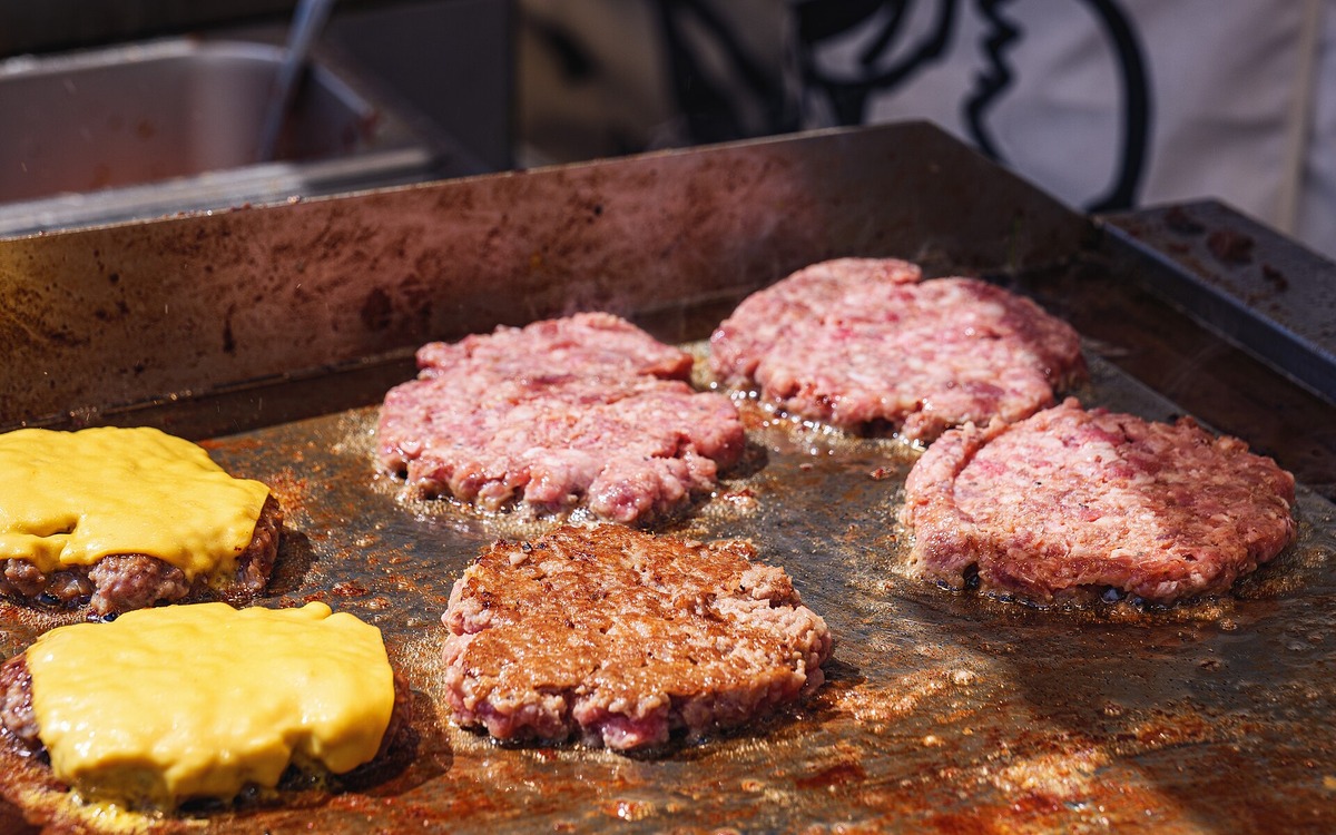 Cooked meat being checked with a digital food thermometer
