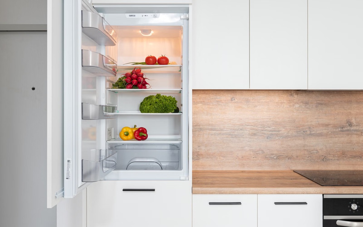 Fresh lettuce and vegetables stored inside a clean refrigerator