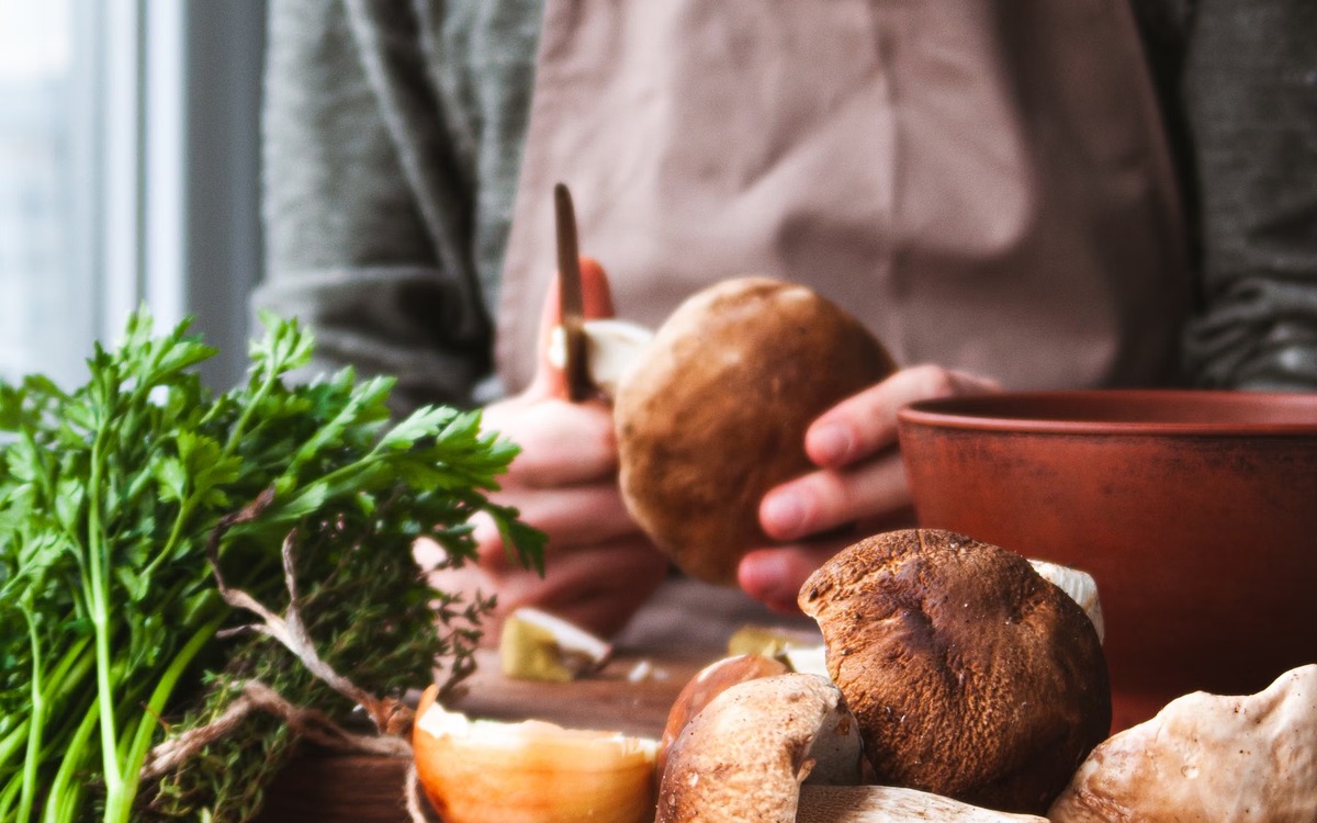 Fresh mushrooms being prepared on a clean kitchen work surface