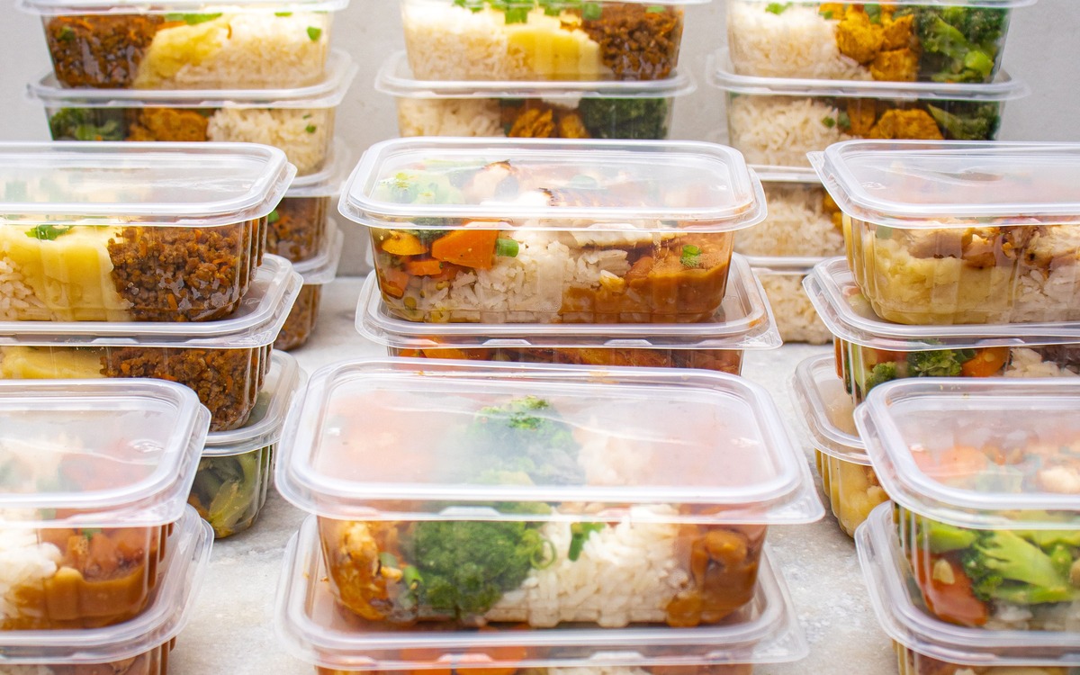 Meal-prep containers with rice and vegetables arranged for refrigerated storage