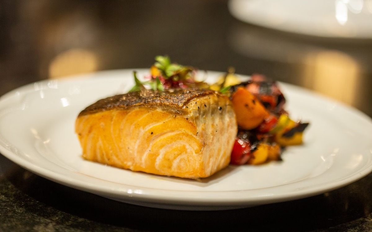 Cooked salmon served on a plate after safe preparation