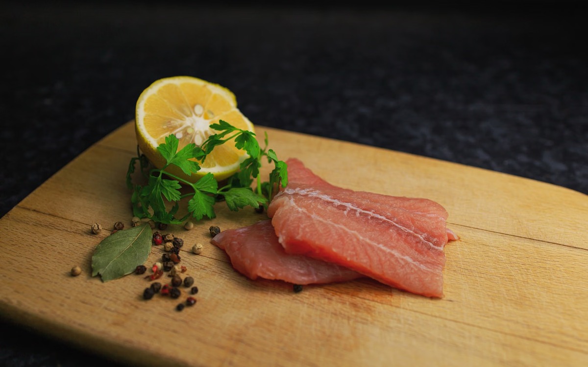 Raw salmon prepared in a kitchen as an example of safe thawing and handling