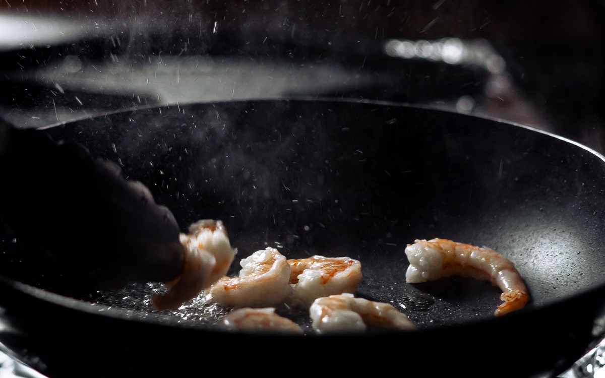 Cooked shrimp with firm opaque flesh showing a safe doneness cue