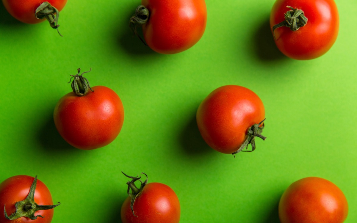 Ripe red tomatoes arranged together as they finish ripening for kitchen use