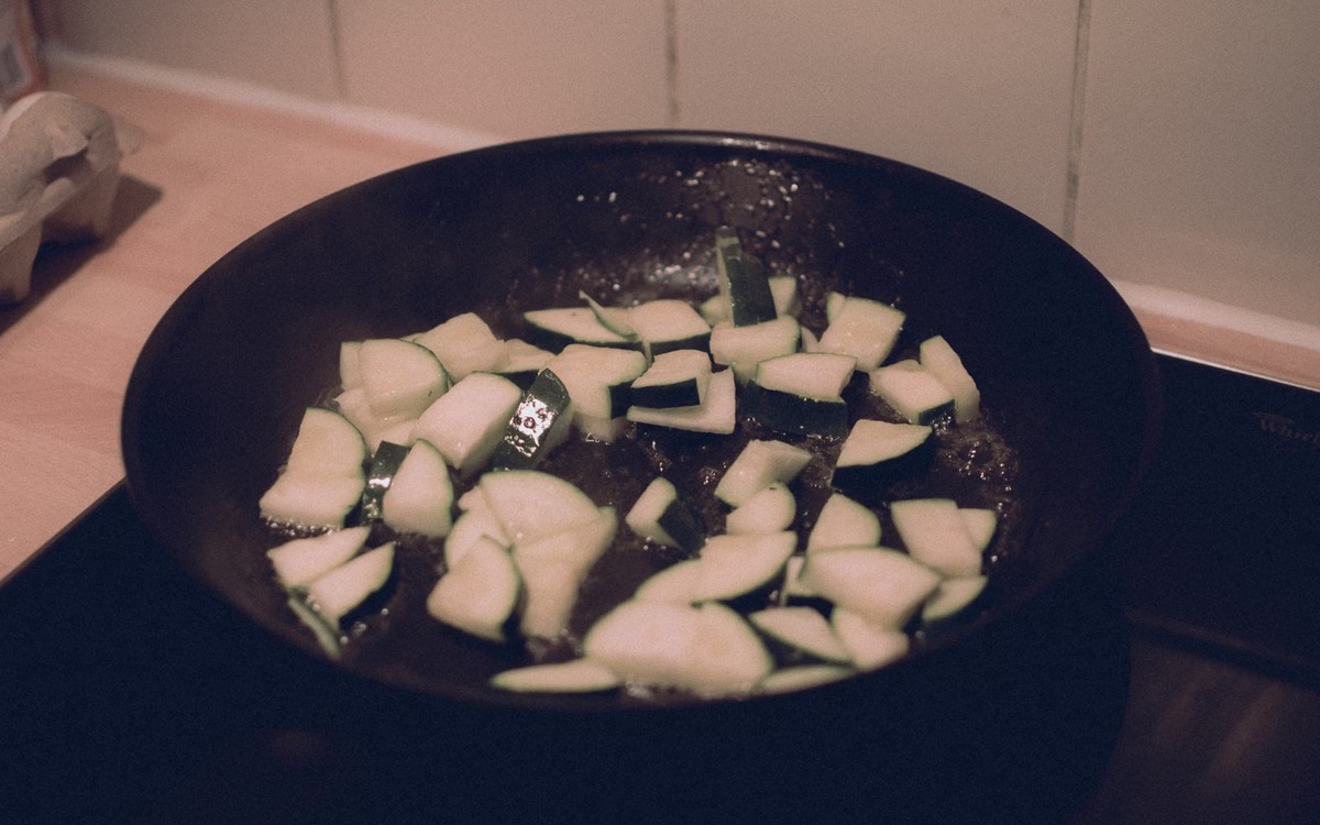 Sliced zucchini cooking in a skillet