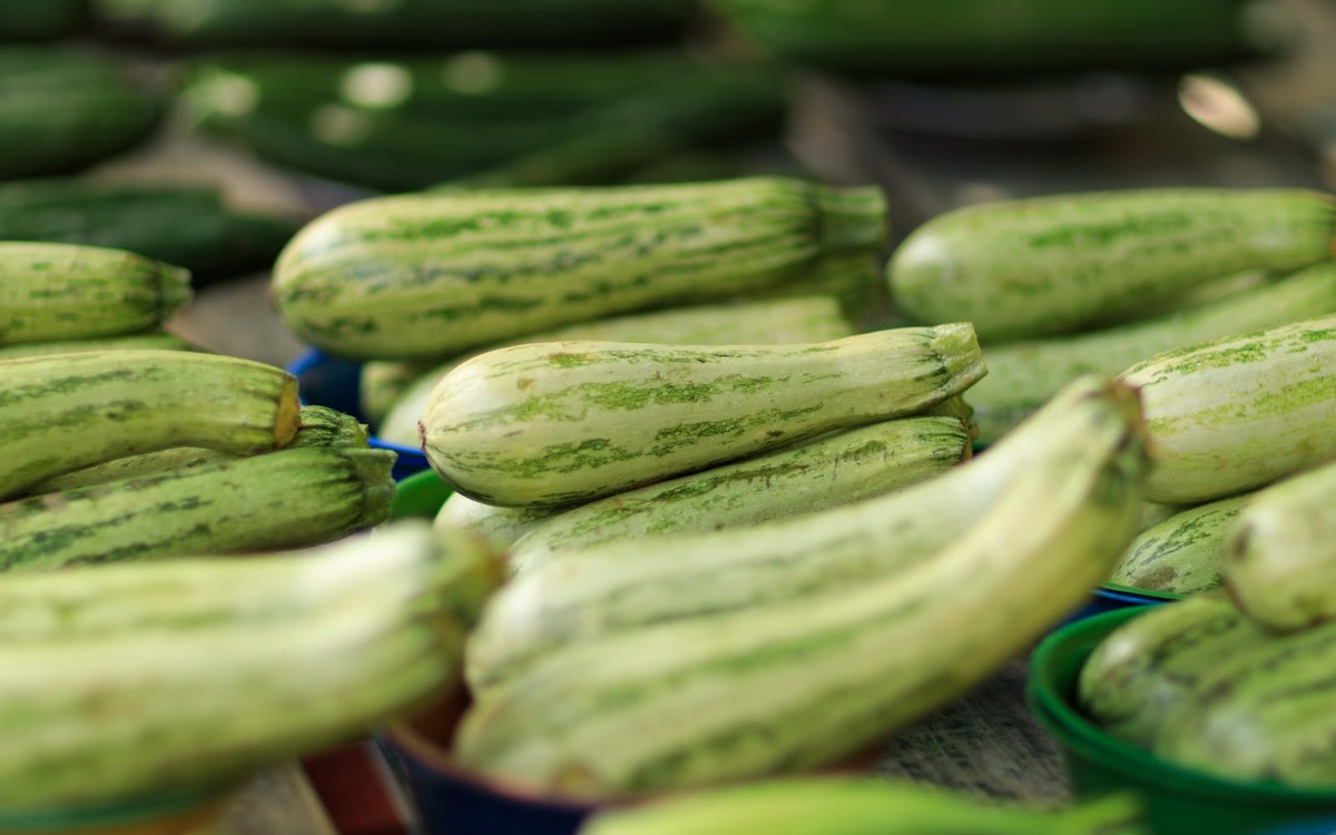 Fresh green zucchini displayed at a produce market